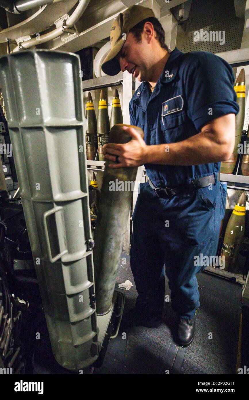 230107-N-XX566-1005 PHILIPPINE SEA (Jan. 7, 2022) U.S. Navy Gunner’s Mate 3rd Class Lain Gibbons loads a simulation round into the 5-inch main gun aboard the Arleigh Burke-class guided-missile destroyer USS Chung-Hoon (DDG 93). Chung-Hoon, part of the Nimitz Carrier Strike Group, is currently underway in 7th Fleet conducting routine operations. 7th Fleet is the U.S. Navy's largest forward-deployed numbered fleet, and routinely interacts and operates with 35 maritime nations in preserving a free and open Indo-Pacific region. Stock Photo