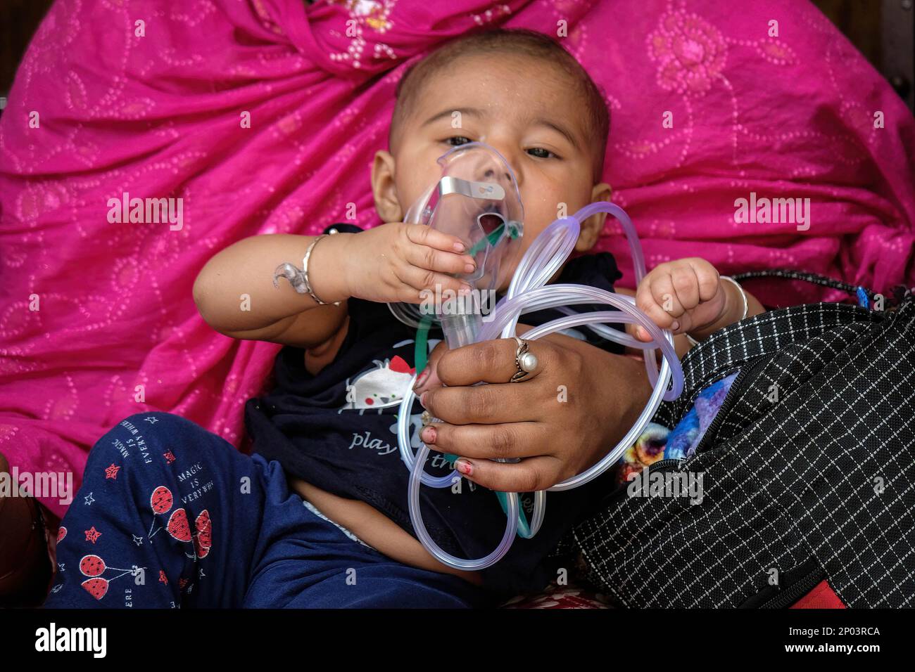Kolkata, India. 02nd Mar, 2023. A child holding an oxygen mask waits