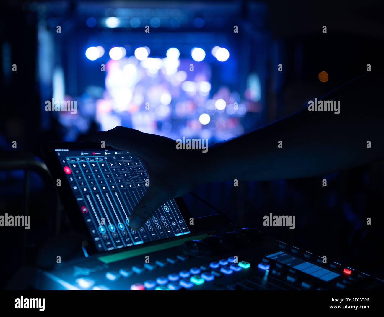 Sound Technician operating audio board at music festival stage Stock ...