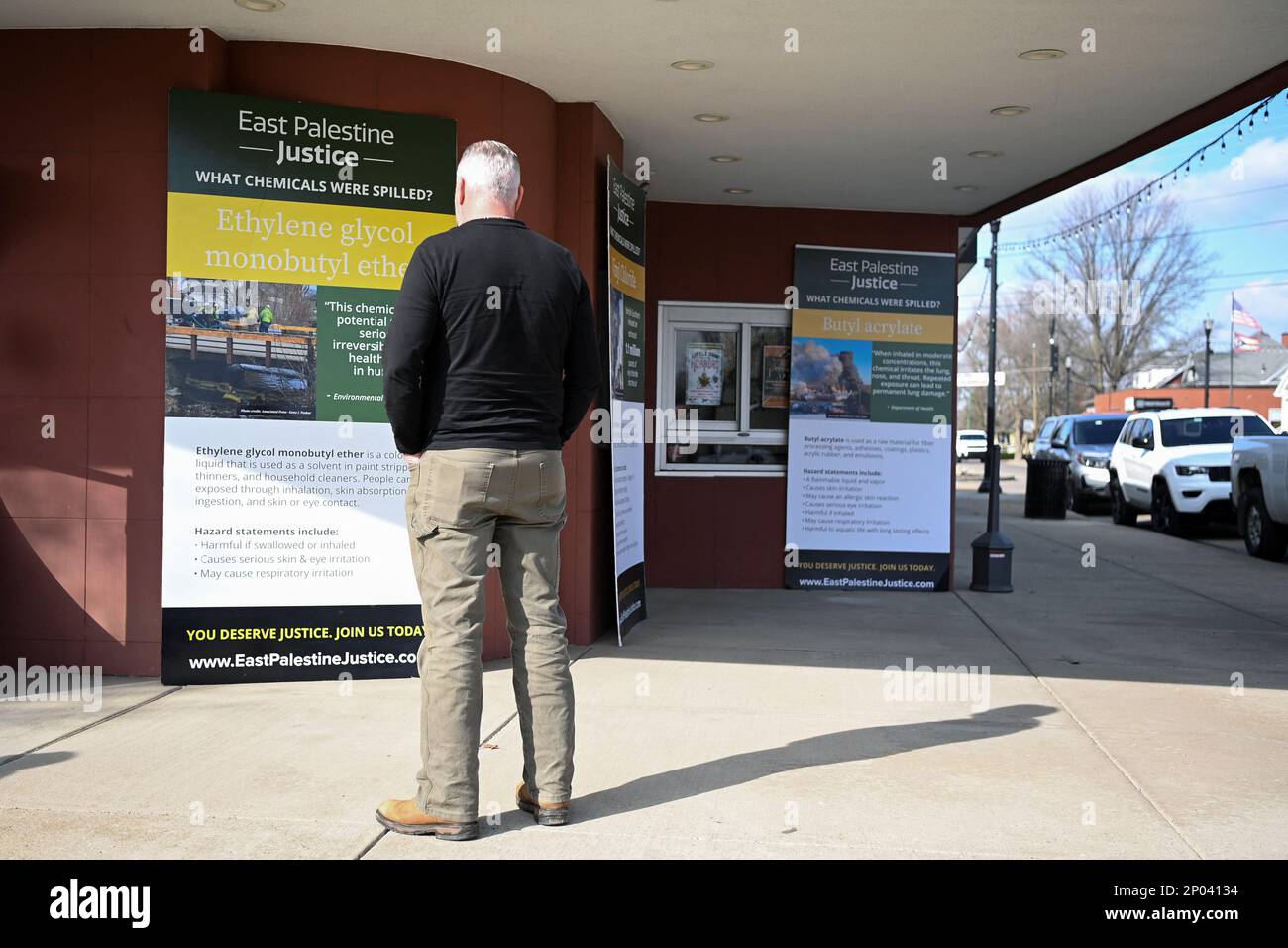 A person looks at informational posters following the train derailment