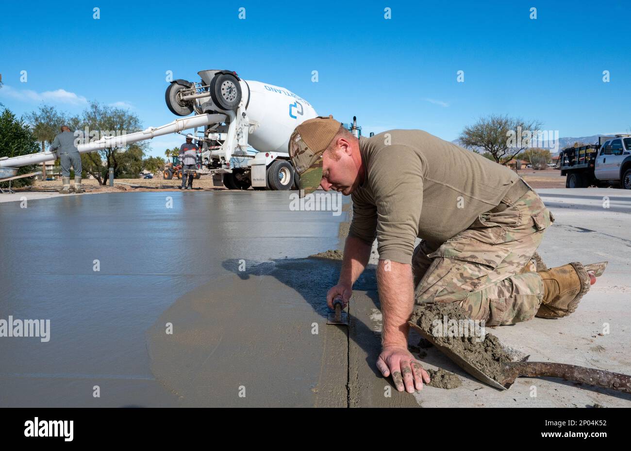 Tech. Sgt. Jeffrey Nix, assigned to the 355th Civil Engineer Squadron, smooths concrete at Davis-Monthan Air Force Base, Ariz., Jan. 17, 2023. Nix took part in the project to create a drill pad for the DM honor guard team. Stock Photo