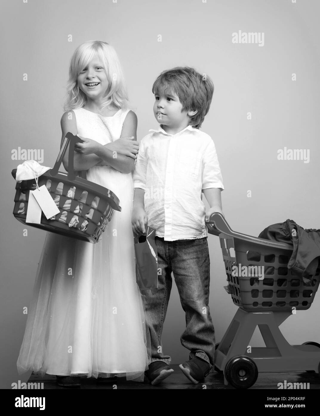 Girl and boy children shopping. Couple kids hold plastic shopping basket toy. Kids store. Mall shopping. Buy products. Play shop game. Cute buyer Stock Photo