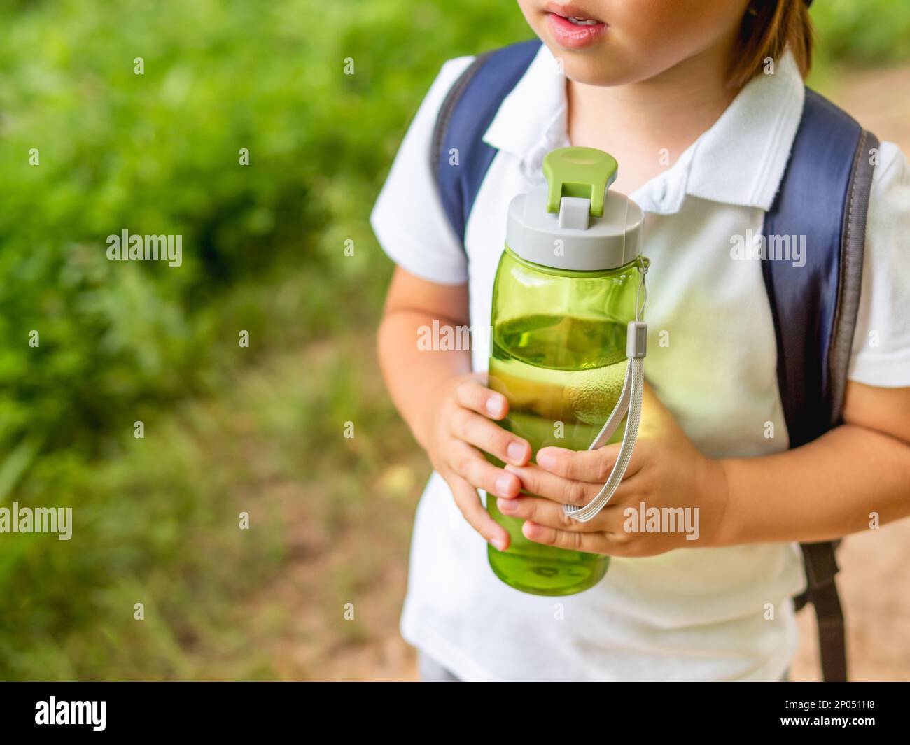 https://c8.alamy.com/comp/2P051H8/thirsty-boy-holds-in-hands-reusable-green-bottle-with-pure-water-summer-outdoor-recreation-healthy-lifestyle-2P051H8.jpg