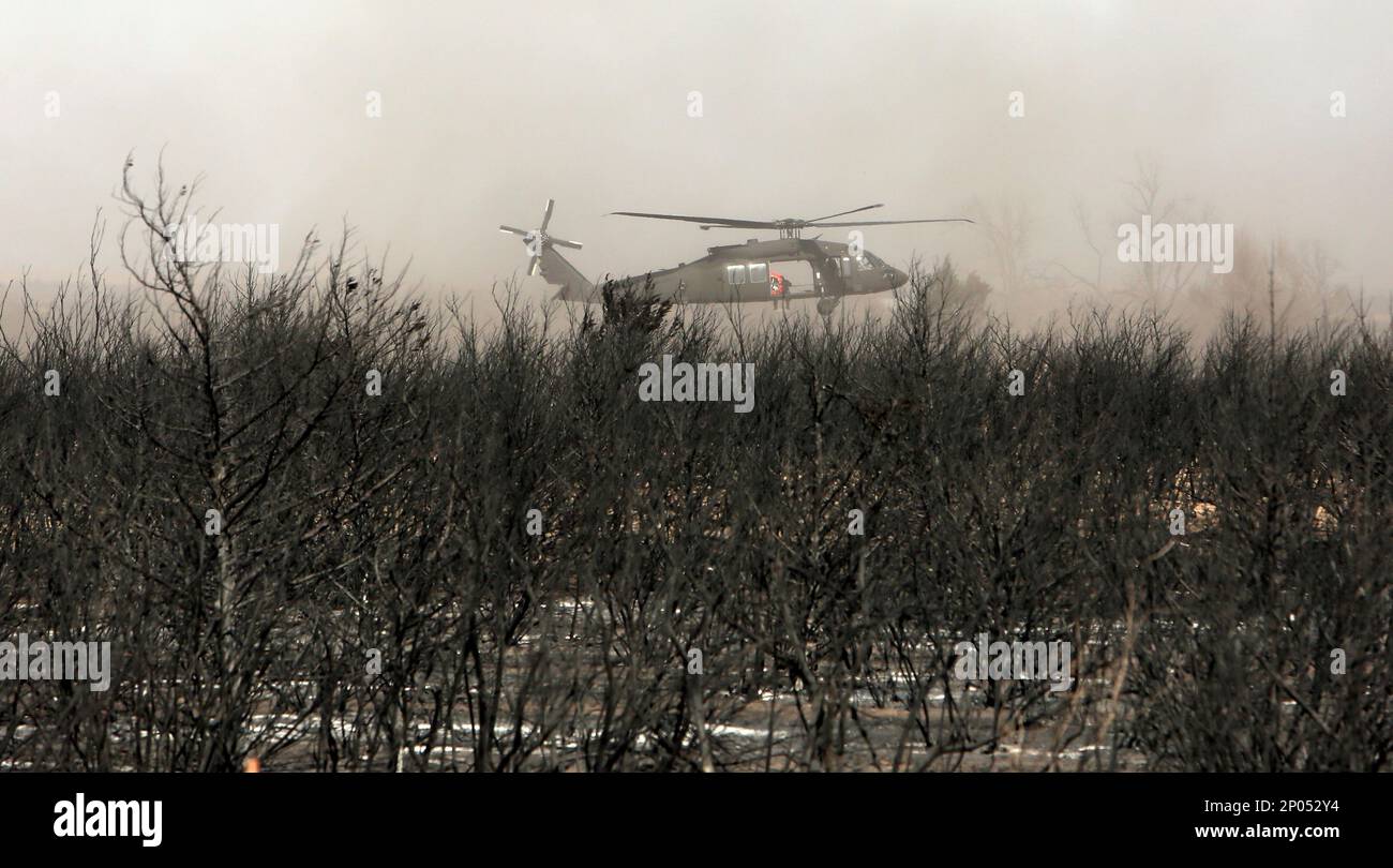 In a Thursday, March 9, 2017 photo, a helicopter flies in low above the