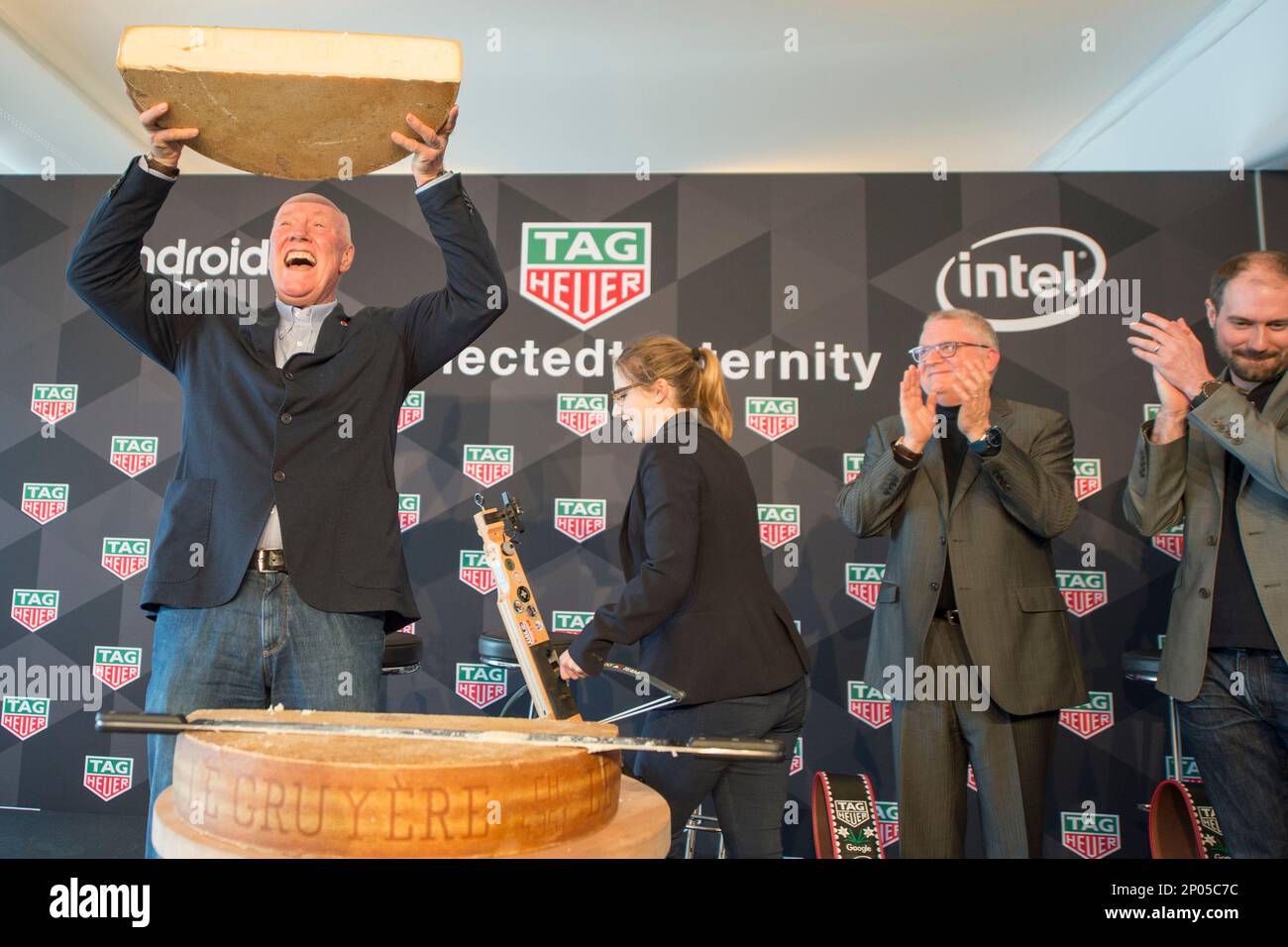 The CEO of TAG Heuer, Jean-Claude Biver, left, presents a cheese at the  press conference of the Watch company TAG Heuer in Brunnen, Switzerland  Tuesday, March 14, 2017. (Urs Flueeler/Keystone via AP