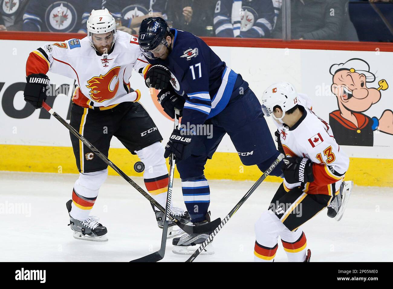 Calgary Flames TJ Brodie 7 and Winnipeg Jets Adam Lowry 17