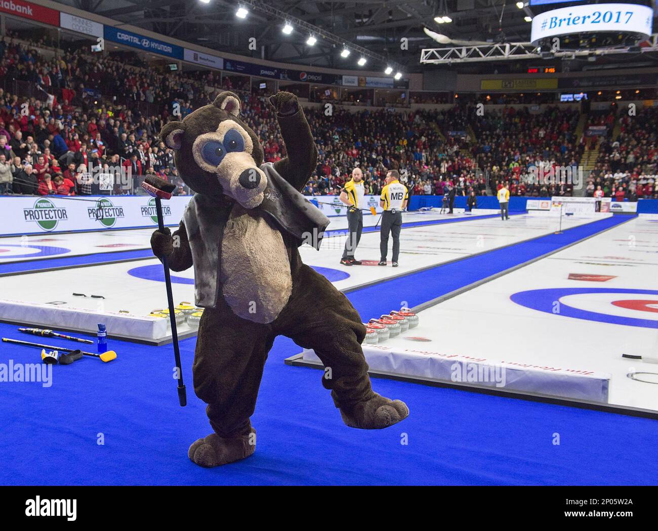 Reg Caughie, who has entertained curling fans as the mascot Brier Bear, salutes the crowd after being named to the Canadian Curling Hall of Fame, at the Tim Hortons Brier curling championship