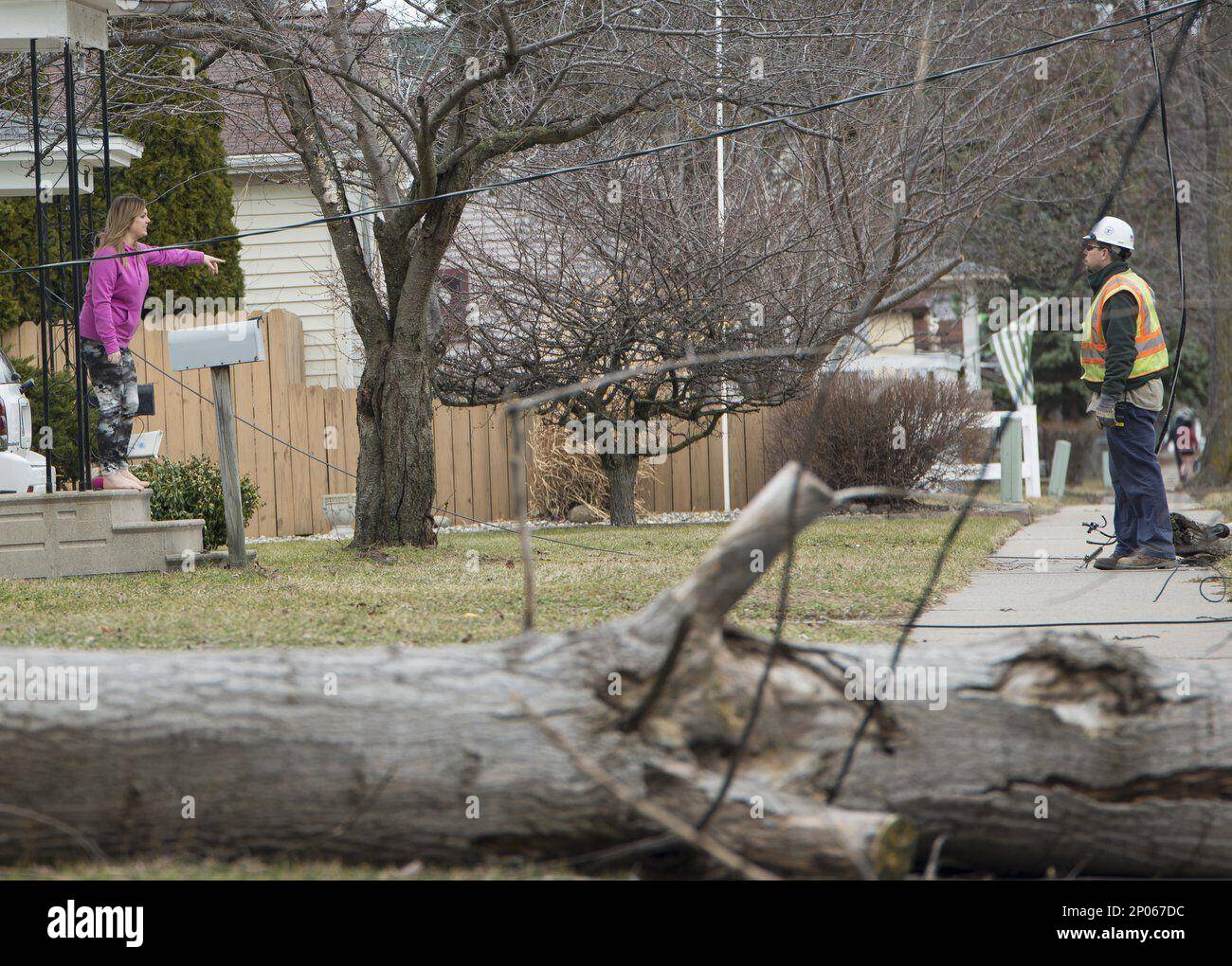 A Bay City Light, Electric & Power employee talks with a citizen at her