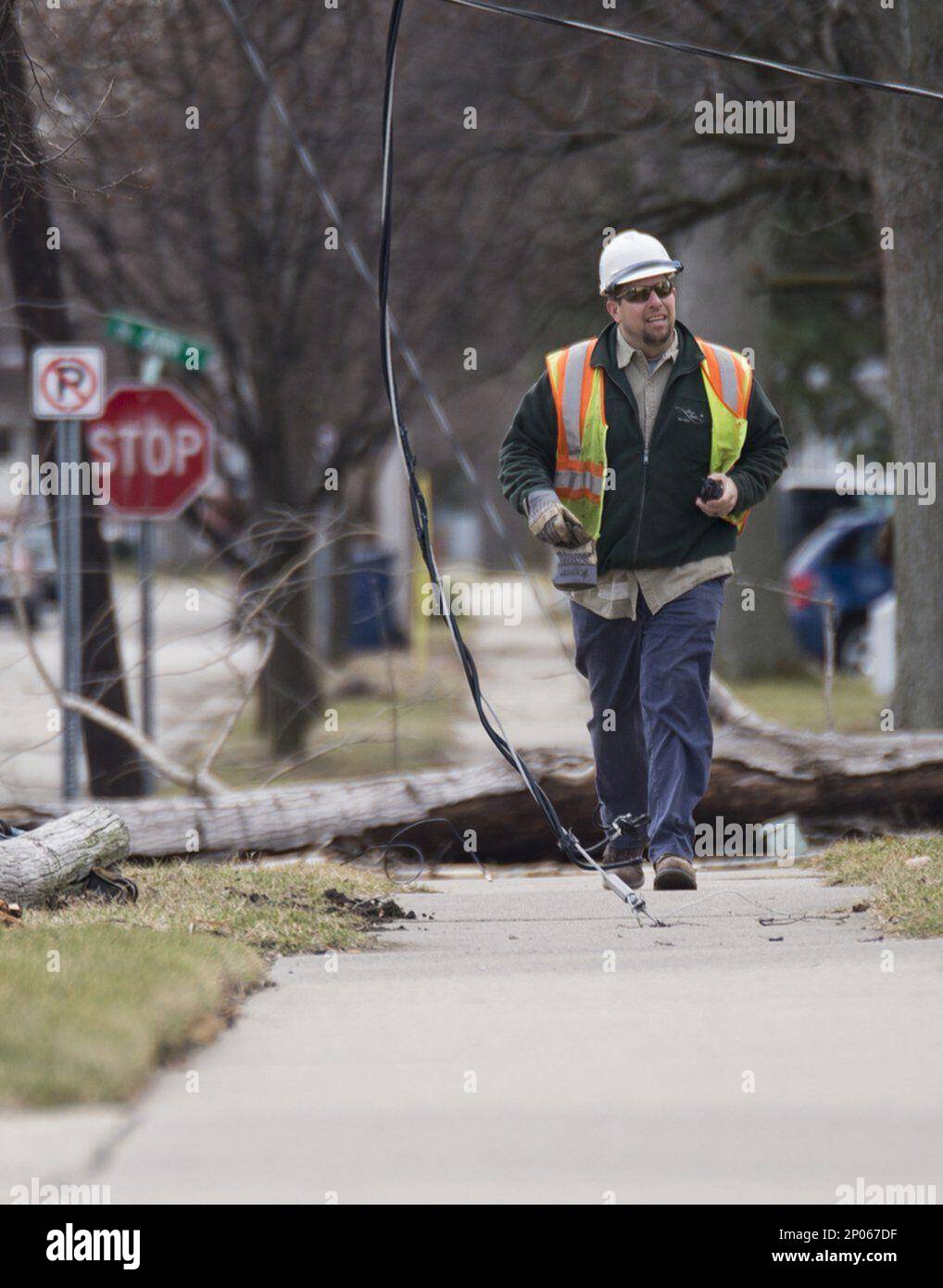 A Bay City Electric, Light & Power employee assesses damage on King