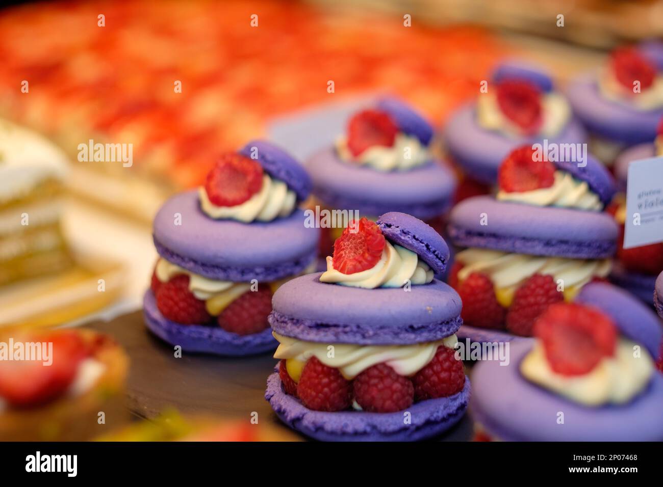 Raspberry Macaron in a London pastry showcase Stock Photo