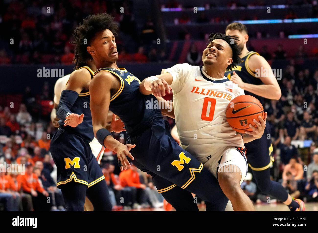 Illinois' Terrence Shannon Jr. (0) drives the basket and fouls Michigan