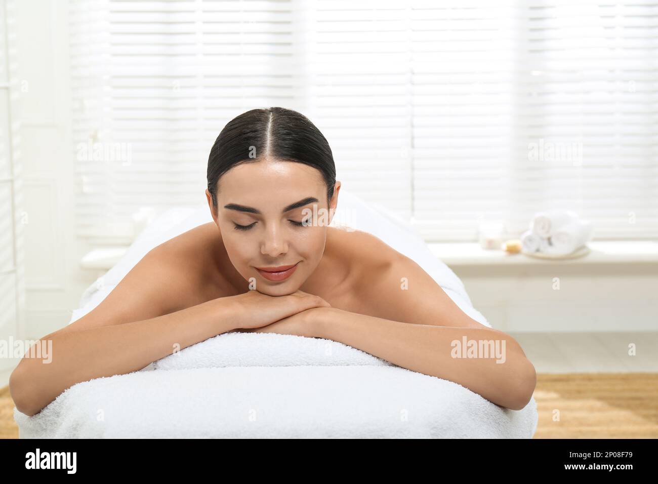 Beautiful young woman relaxing in spa salon Stock Photo - Alamy
