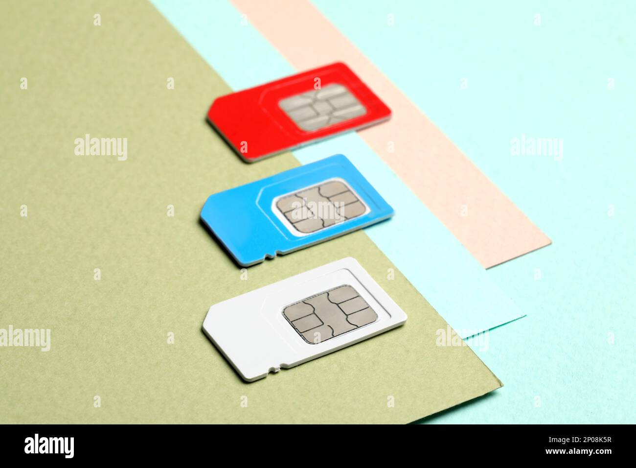 Different SIM cards on color background, closeup Stock Photo