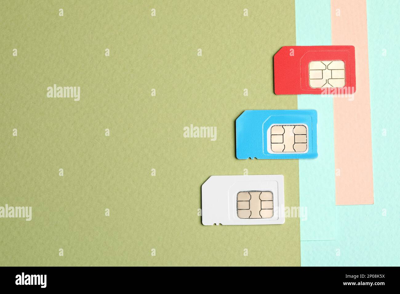 Different SIM cards on color background, flat lay. Space for text Stock Photo