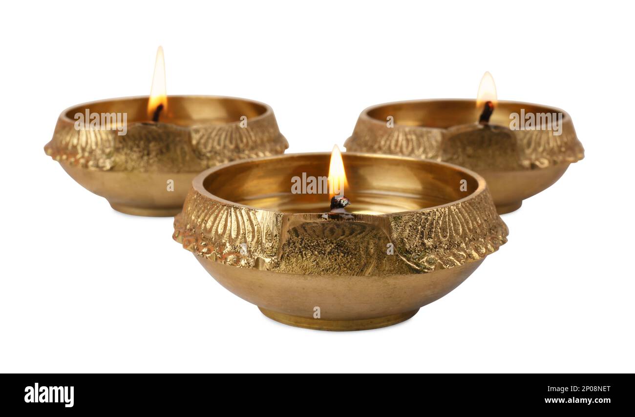 Lit diya lamps on white background. Diwali celebration Stock Photo