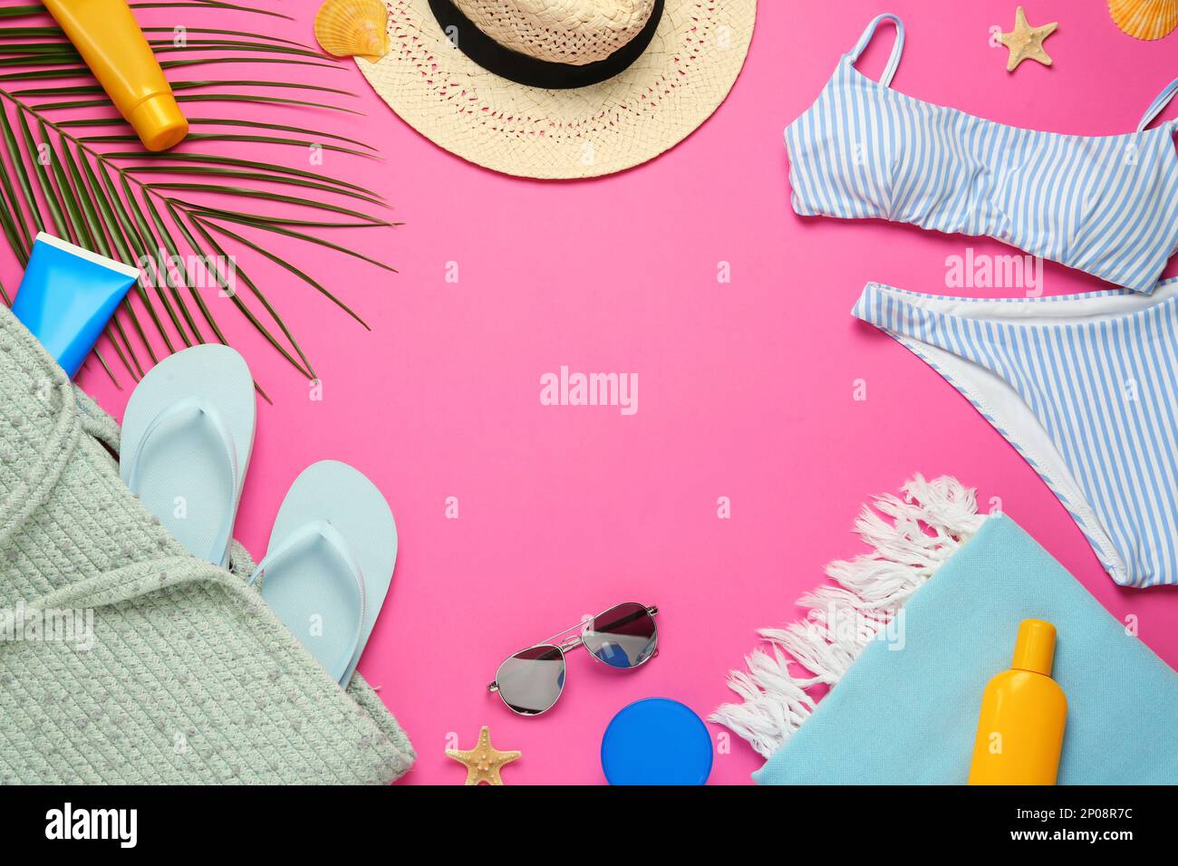 Frame made with different beach objects on pink background, flat lay. Space for text Stock Photo