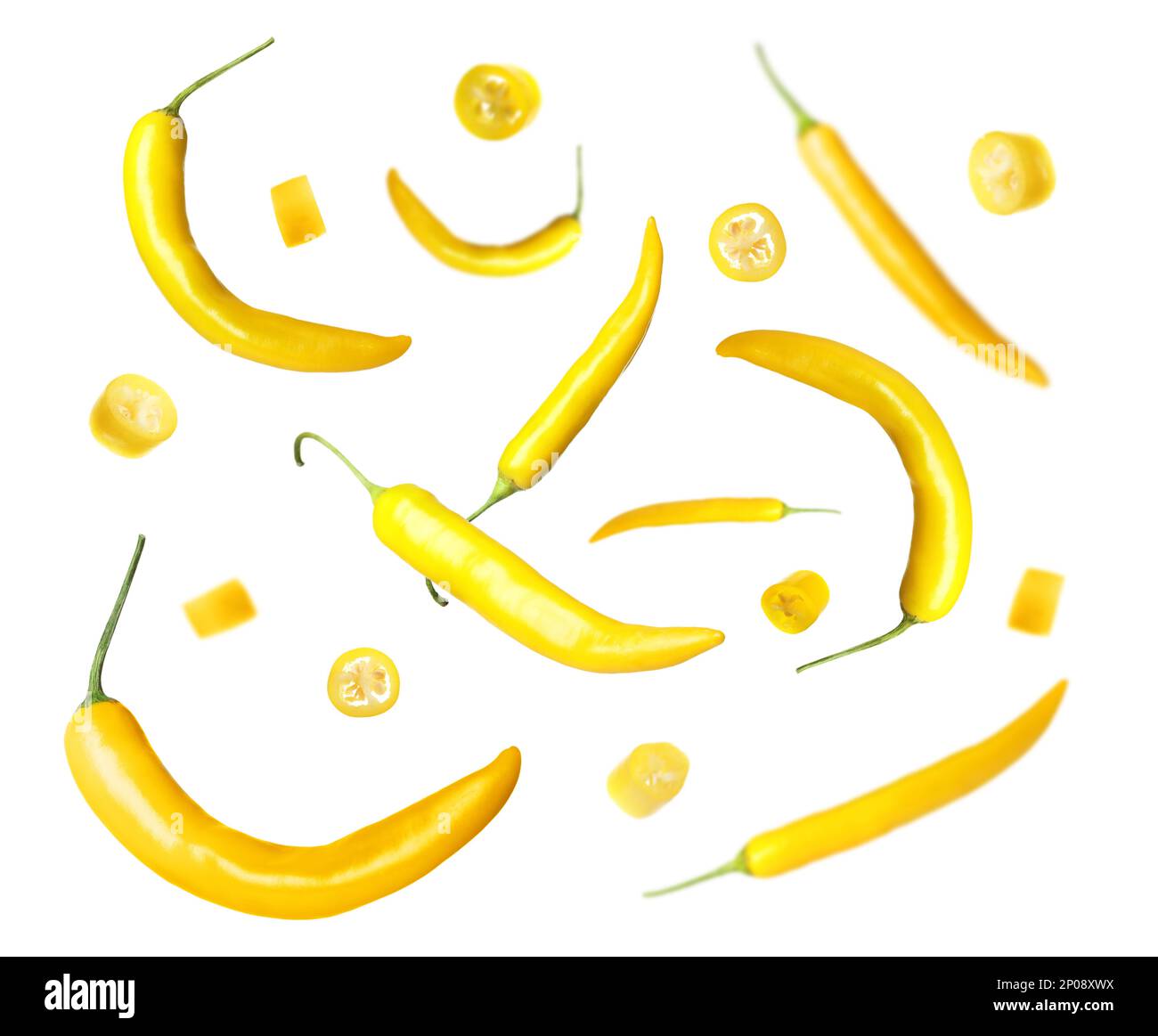 Ripe yellow chili peppers falling on white background Stock Photo - Alamy