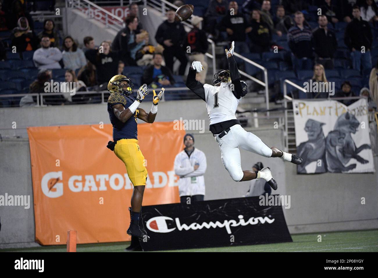 St. Thomas Aquinas receiver Joshua Palmer (5) and Tampa Plant defensive  back Whop Philyor (1) battle for a pass in the end zone during the first  half of the FHSAA Class 7A