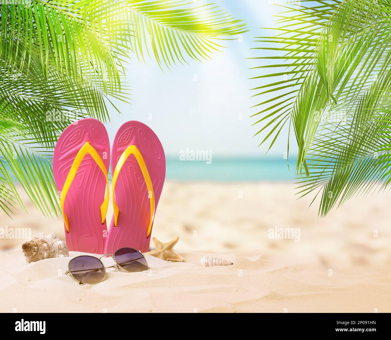 Pink flip flops, starfish, sea shell and sunglasses on sandy beach near ...