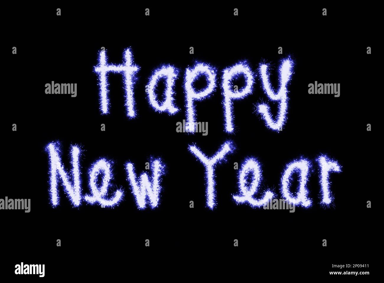 Close-up on a the short phrase 'Happy New Year' made of blue sparks on a black background. Stock Photo
