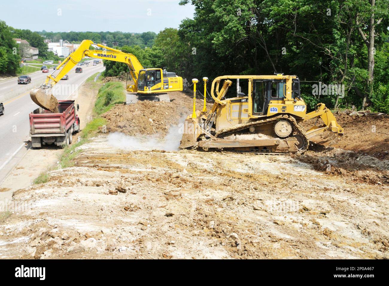 Heavy equipment operators from Emery Sapp and Sons continue to dig down ...