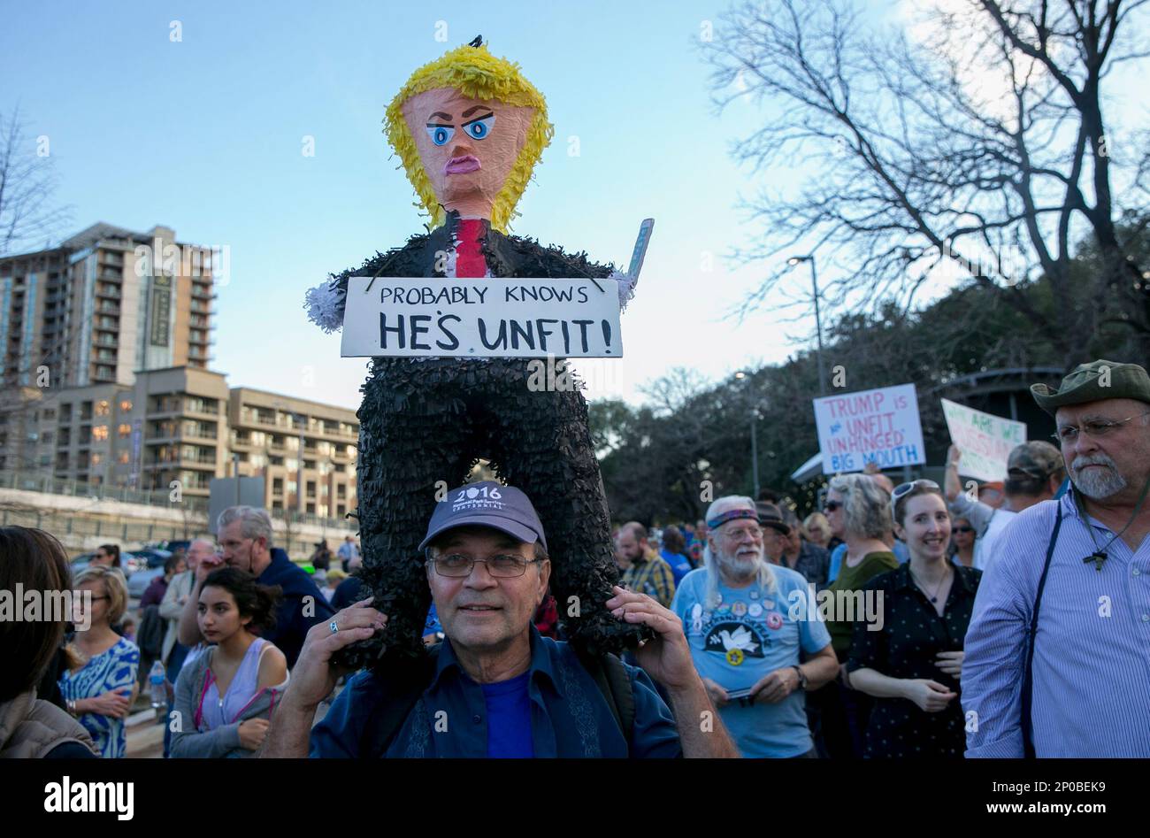 Anti-Trump protester Howard Porter hold a Trump pinata at Vic Mathias ...