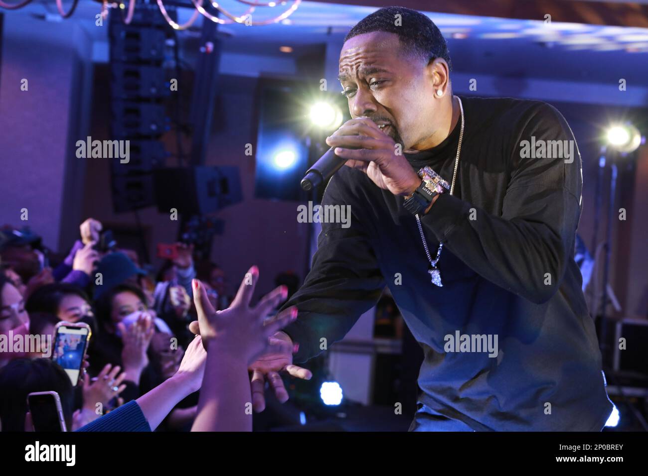 Dru Hill member Tao extends his hand to an audience member while singing during the group’s concert Jan. 10 at the Camp Zama Community Club at Camp Zama, Japan. The group was in Japan as part of a tour of U.S. military bases in Asia in conjunction with Armed Forces Entertainment. Stock Photo
