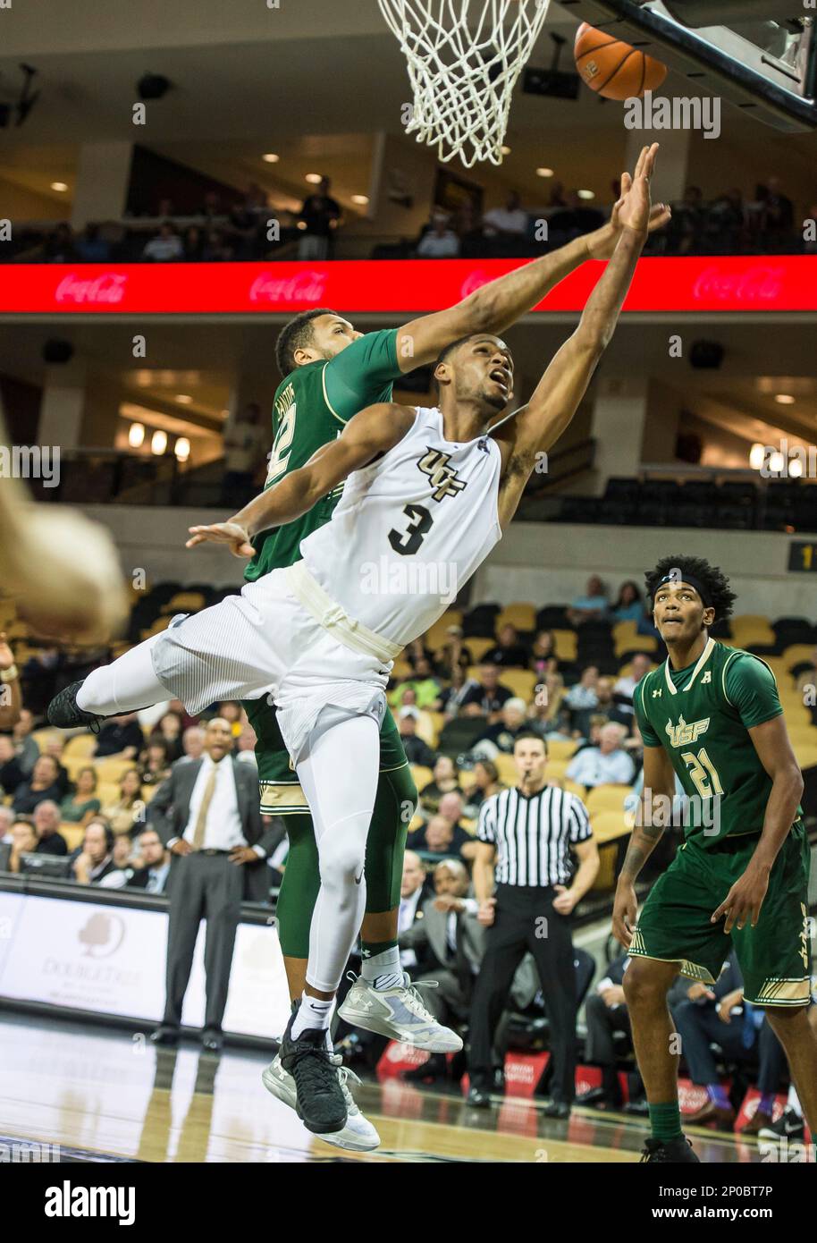 January 17, 2017 - Orlando, FL, U.S: Central Florida guard A.J. Davis (3)  is fouled under the basket by South Florida forward Luis Santos (42) during  a NCAA basketball game between the