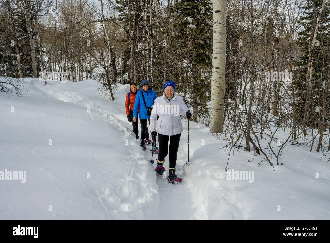Three women (released), including a 90 year ols senior, snowshoeing at the Nordic Center of the Sundance Resort, also known as Sundance Mountain Resor Stock Photo