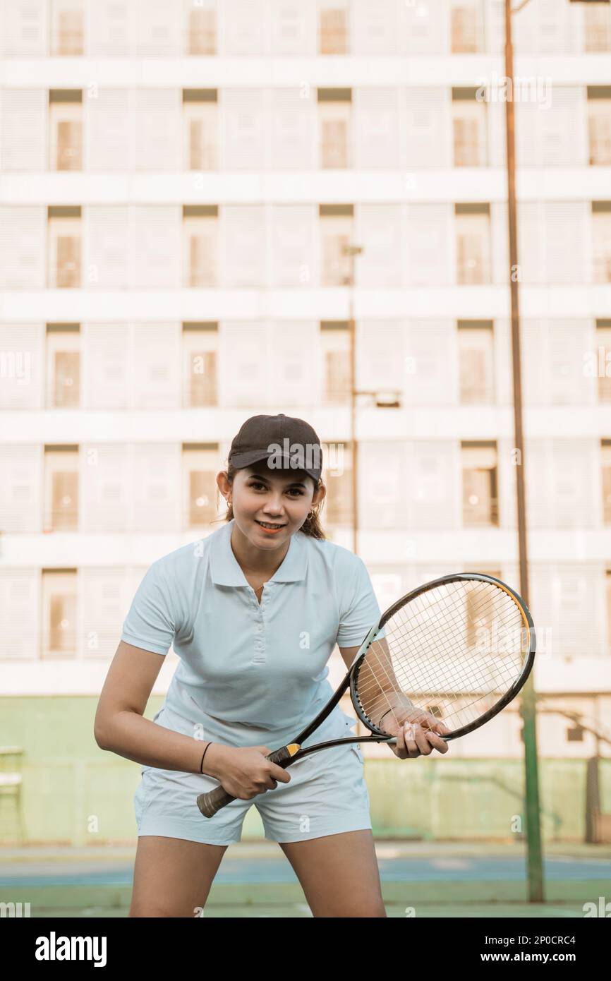 Asian tennis athlete holding a racket in a ready position Stock Photo ...