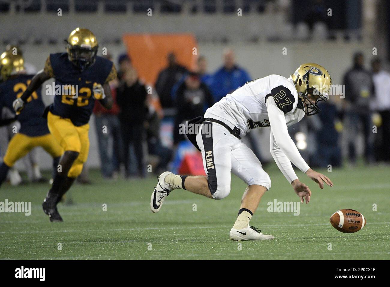 Plant punter Nick Rice, right, recovers an errant snap in front of St ...