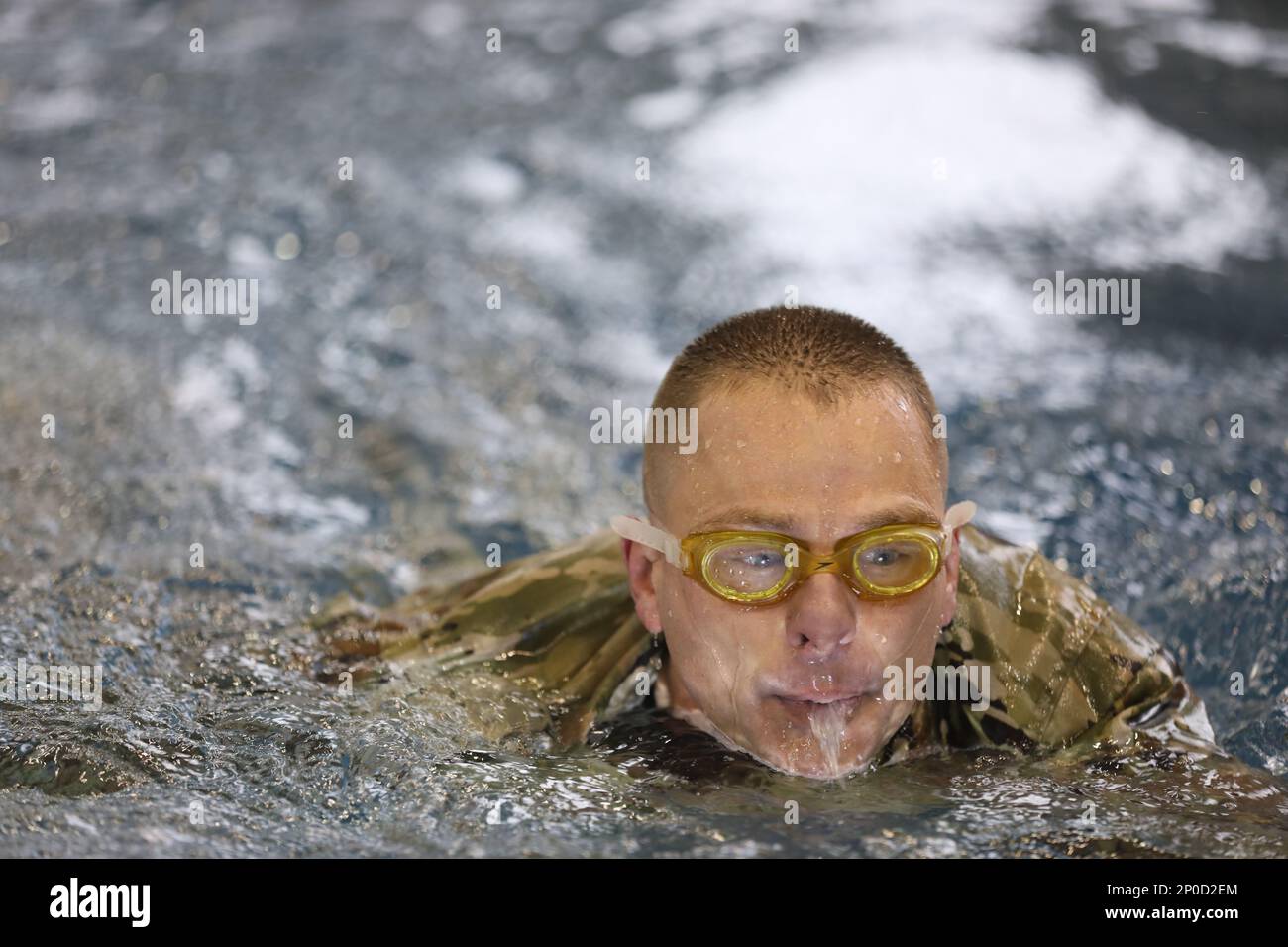 A Soldier conducts an Army Water Survival Assessment at the Lt. Gen. Thomas S. Vandal Training Complex on Camp Humphreys, South Korea Jan. 27 as part of the 2023 German Armed Forces Proficiency Badge. To qualify for the GAFPB, participants must complete a variety of challenges including a flexed-arm hang for time, a 12-kilometer ruck march with a minimum of a 35-pound ruck, 1,000-meter sprint, an 11 x 10-meter sprint, a pistol marksmanship test, and a 100-meter swim in uniform to be performed under four minutes. Stock Photo