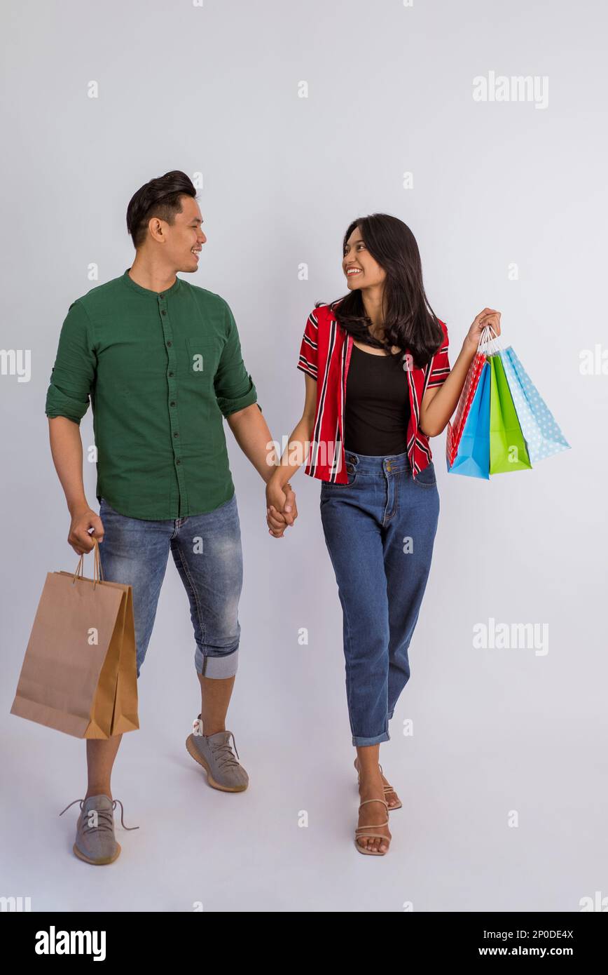 asian couple holding hands and looking at each other Stock Photo - Alamy