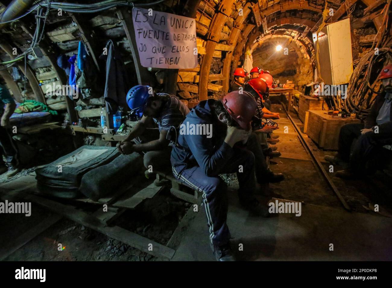 Miners sit during a protest in the Santa Ana mine, some 650 meters (2,100  feet) underground, in Curanilahue, southern Chile, on Saturday, Dec. 31,  2016. More than 60 coal miners have occupied