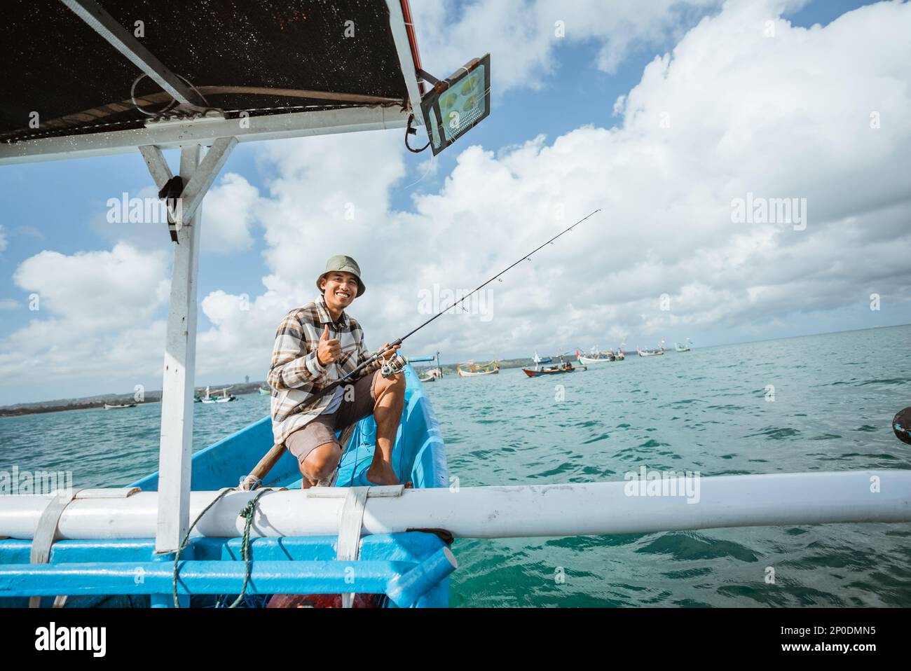 Happy asian male angler hi-res stock photography and images - Alamy