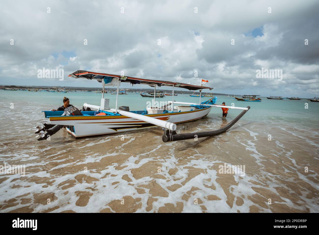 a traditional wooden fishing boat rests on the beach Stock Photo - Alamy
