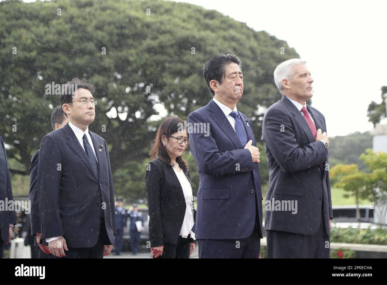 Japanese Prime Minister Shinzo Abe(C) puts his hand on his heart with ...