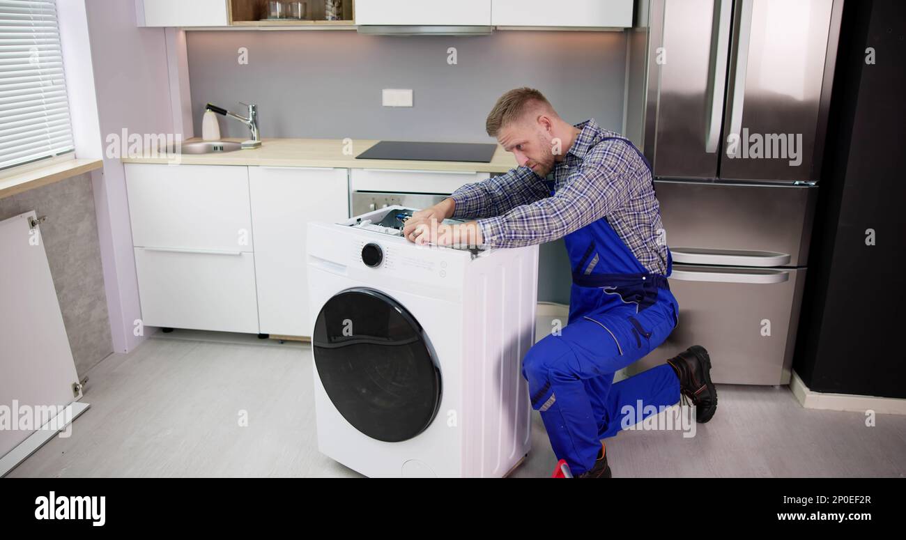 Washing Machine Repair Problem. Man Fixing Appliance Stock Photo Alamy