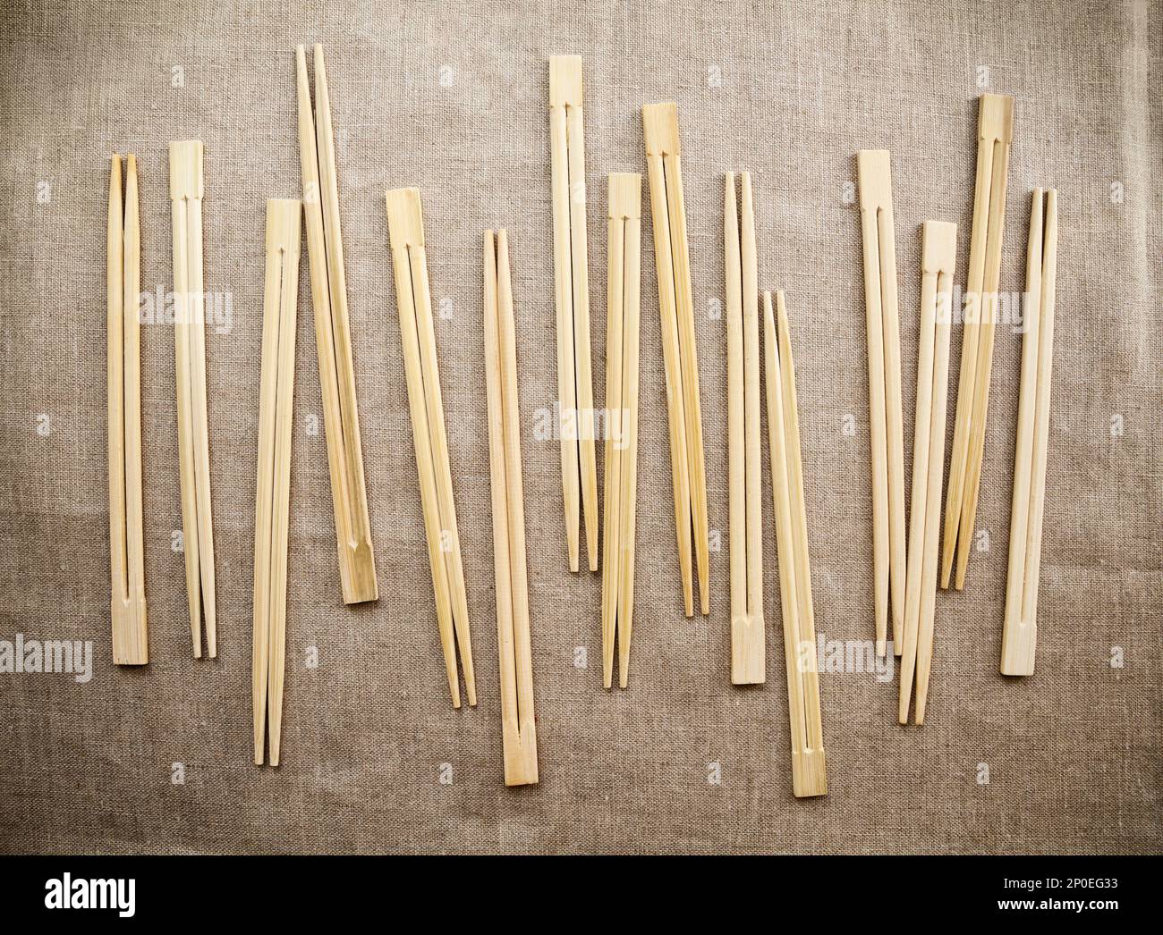 Many Asian wooden chopsticks arranged in a row background. Lots of