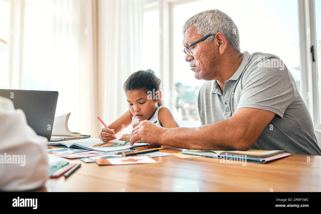 Grandpa help, child learning and home studying in a family house with education and knowledge. Senior man, girl and teaching of a elderly person with Stock Photo