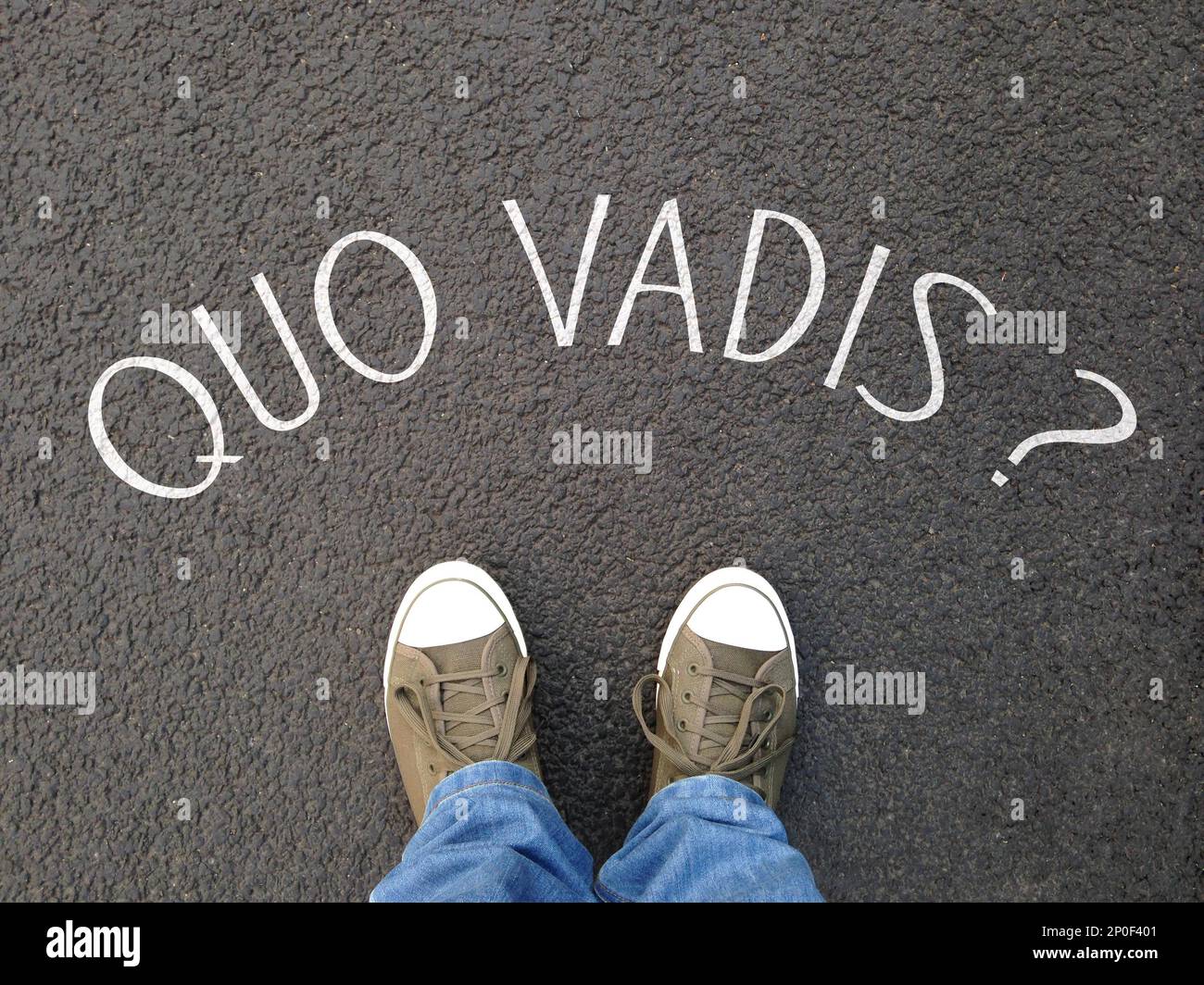 quo vadis is a latin phrase meaning where are you going - foot selfie on street with question written on asphalt - confusion destiny uncertainty Stock Photo