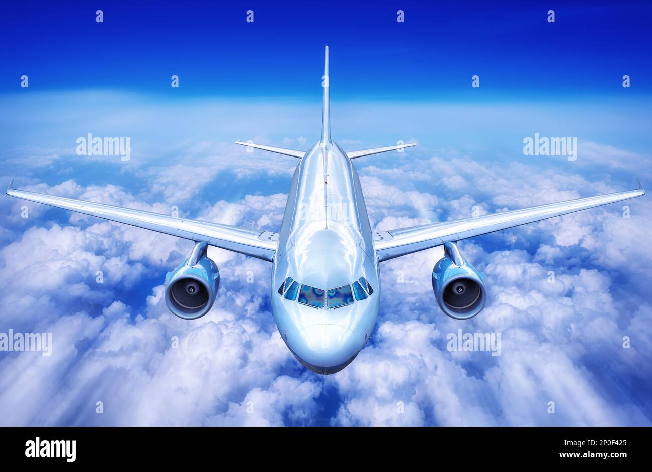 airplane over the clouds Stock Photo