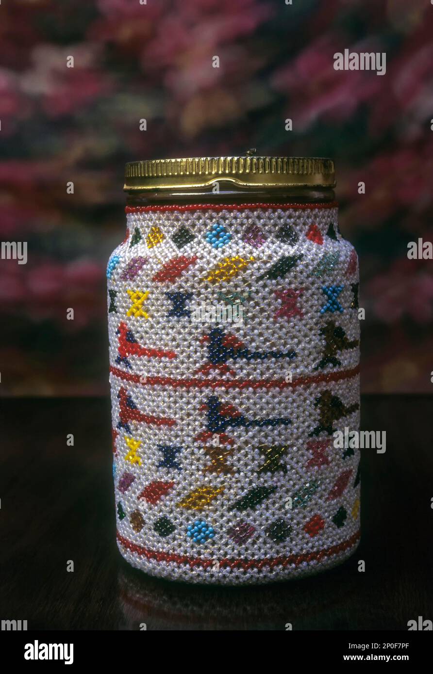Bead works handicraft, Glass bottle, once used to be covered with beadwork work both hobbies once favoured by the chettiar's wife, Nagarathar Stock Photo