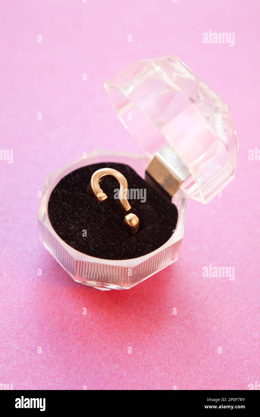 Engagement proposal ring in the shape of a question mark. Concept for