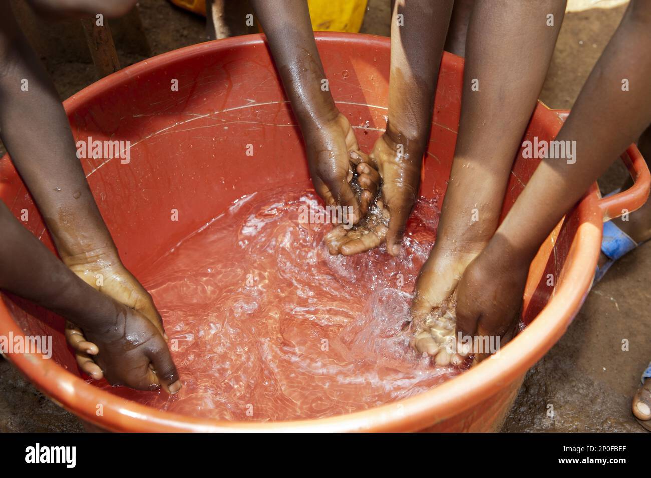 Children wash their hands in fresh, clean water from a well, Rwanda ...