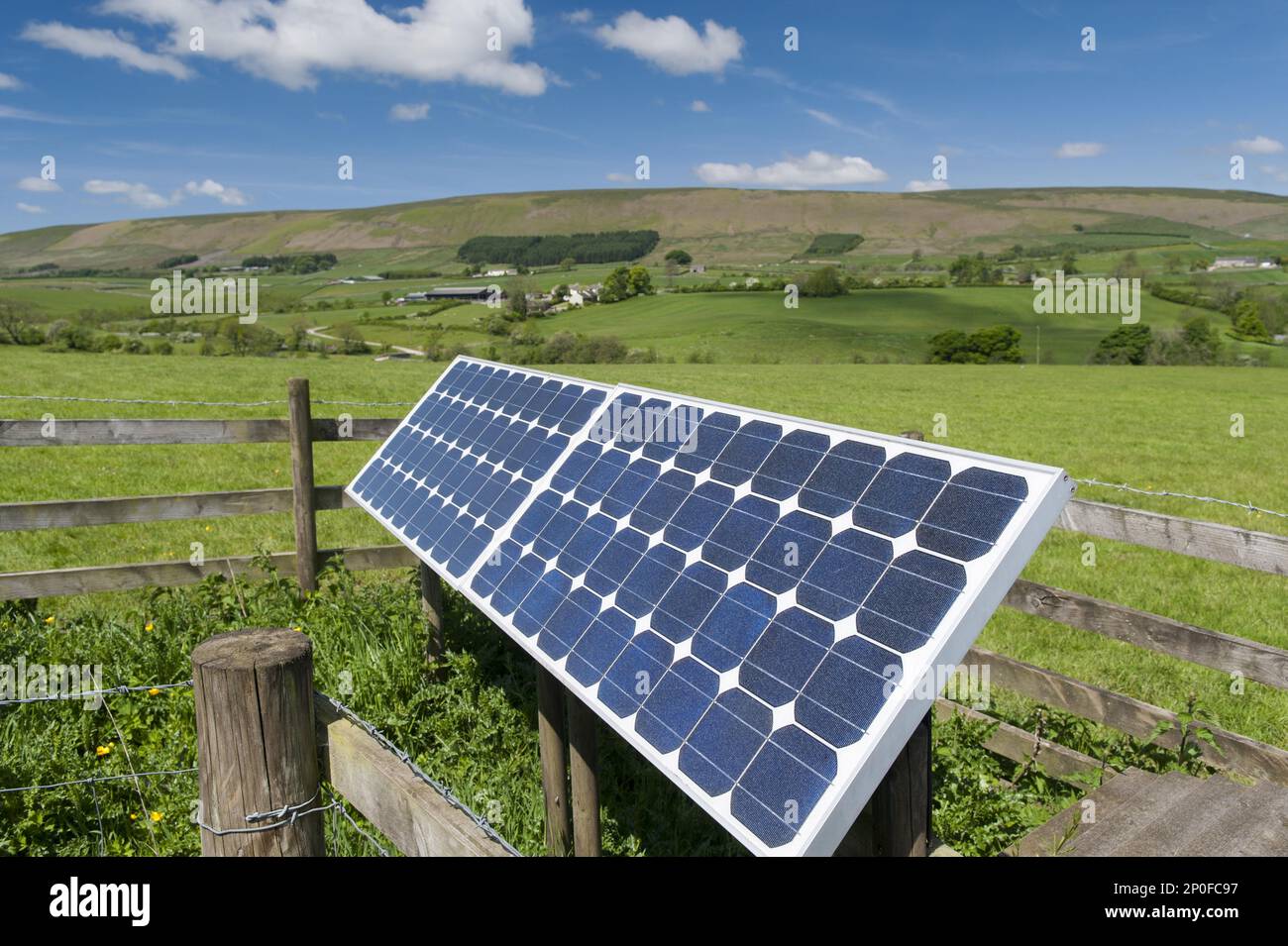 Solar panels on farm to operate electric gate along farm track. Lancashire, Great Britain Stock Photo