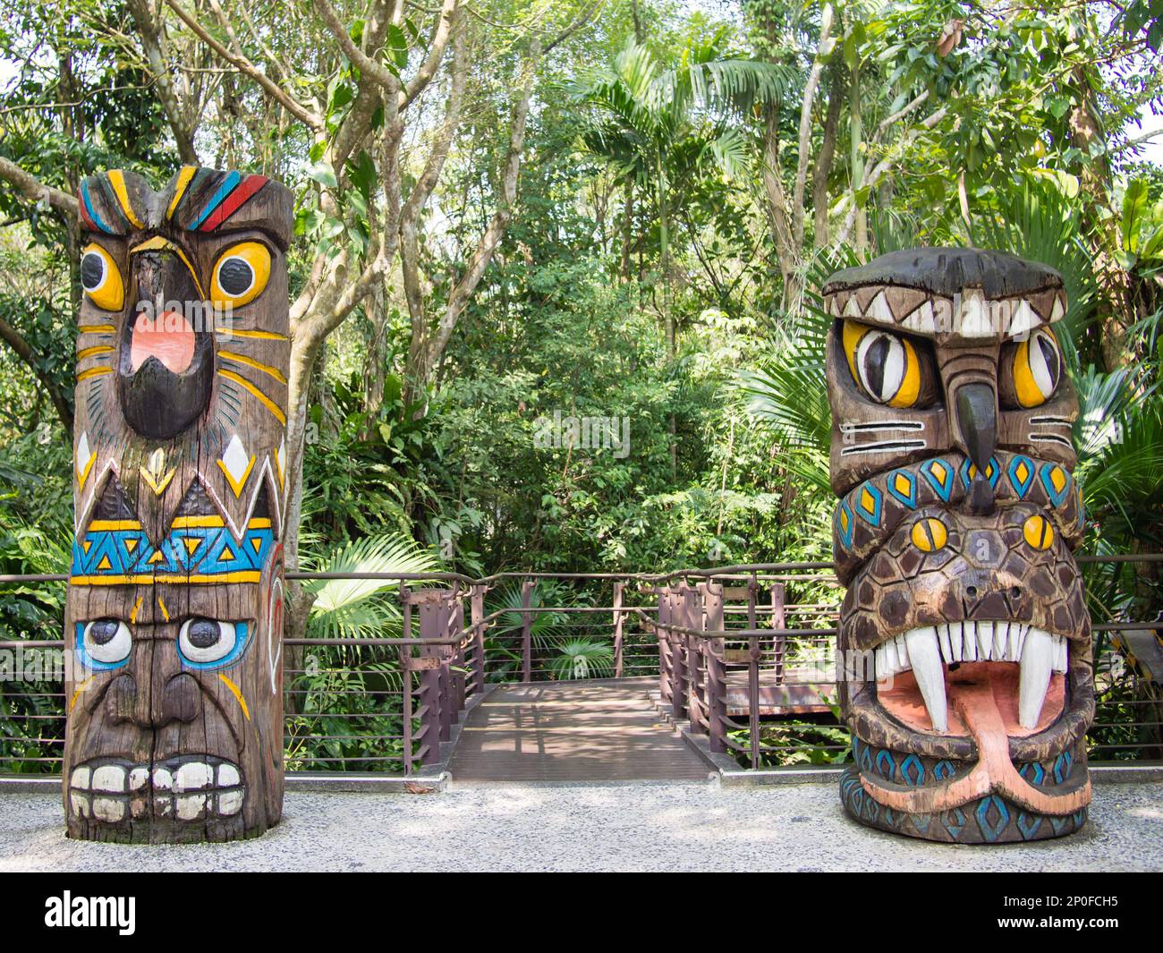 Totem poles engraved with parrot, owl, snake and human face at Taipei Zoo in Taipei, Taiwan. Stock Photo