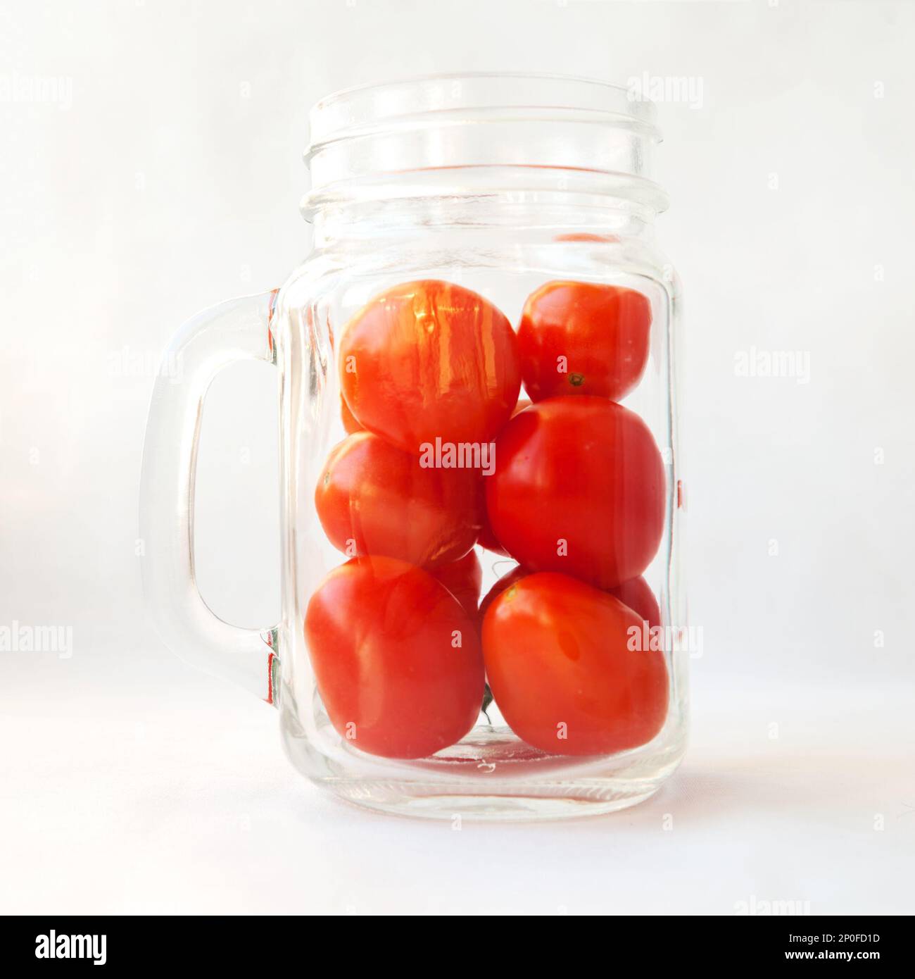 https://c8.alamy.com/comp/2P0FD1D/tomato-juice-drink-smoothie-in-a-glass-concept-plum-tomatoes-in-a-transparent-jar-mug-isolated-on-white-many-small-fresh-red-vegetables-in-a-cup-2P0FD1D.jpg