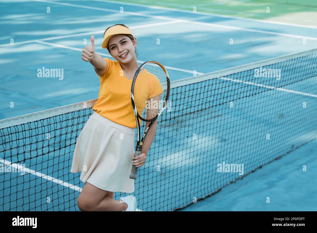 Beautiful tennis player woman with thumbs up while holding racket Stock ...