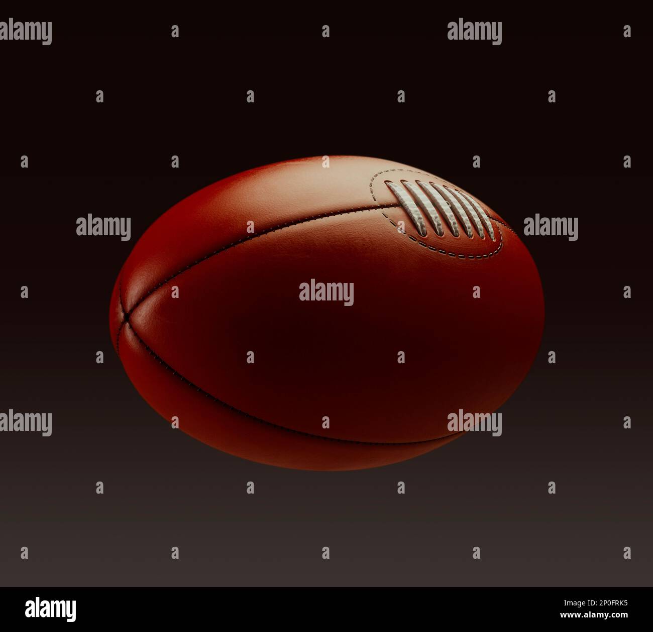 A generic unbranded aussie rules football ball on an isolated dark studio background - 3D render Stock Photo